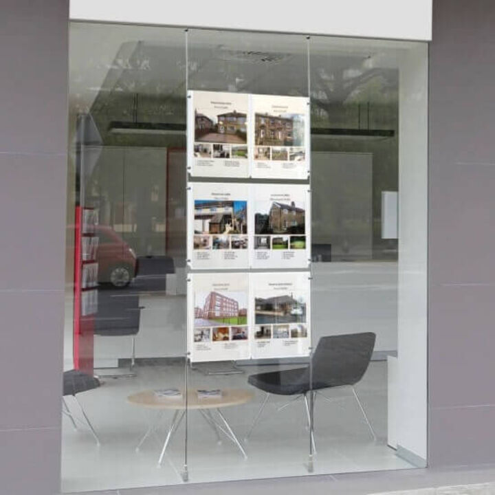 Floor to ceiling cables used within an estate agent's window display.jpg