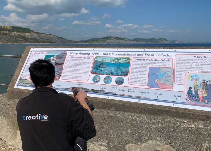 Installing large information display panel at Lyme Regis for Mary Anning Rocks