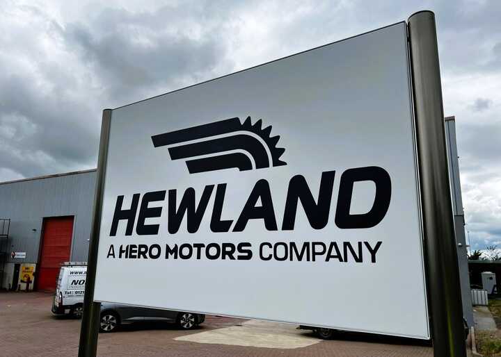 Tailor-made fabricated plaza-style post-mounted tray sign for Hewland Engineering