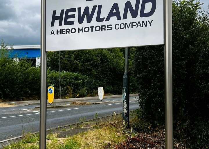 Tailor-made fabricated plaza-style post-mounted tray sign for Hewland Engineering